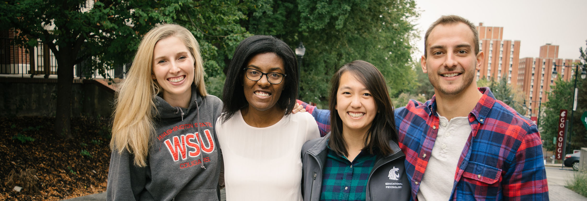Four students smile for a photo on the WSU Pullman campus.